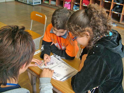 写真:研修の様子 教科書を覗き込む子どもたち